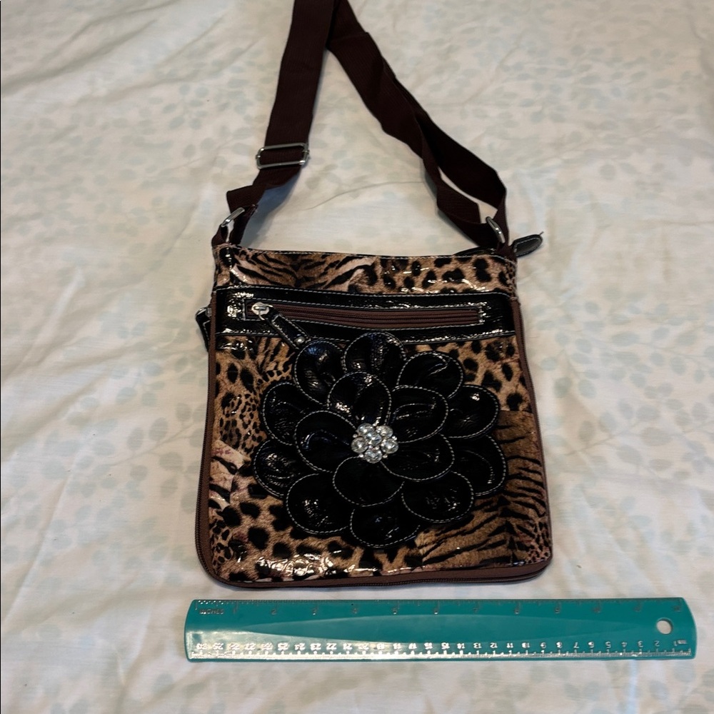 leopard print crossbody bag with glossy black flower